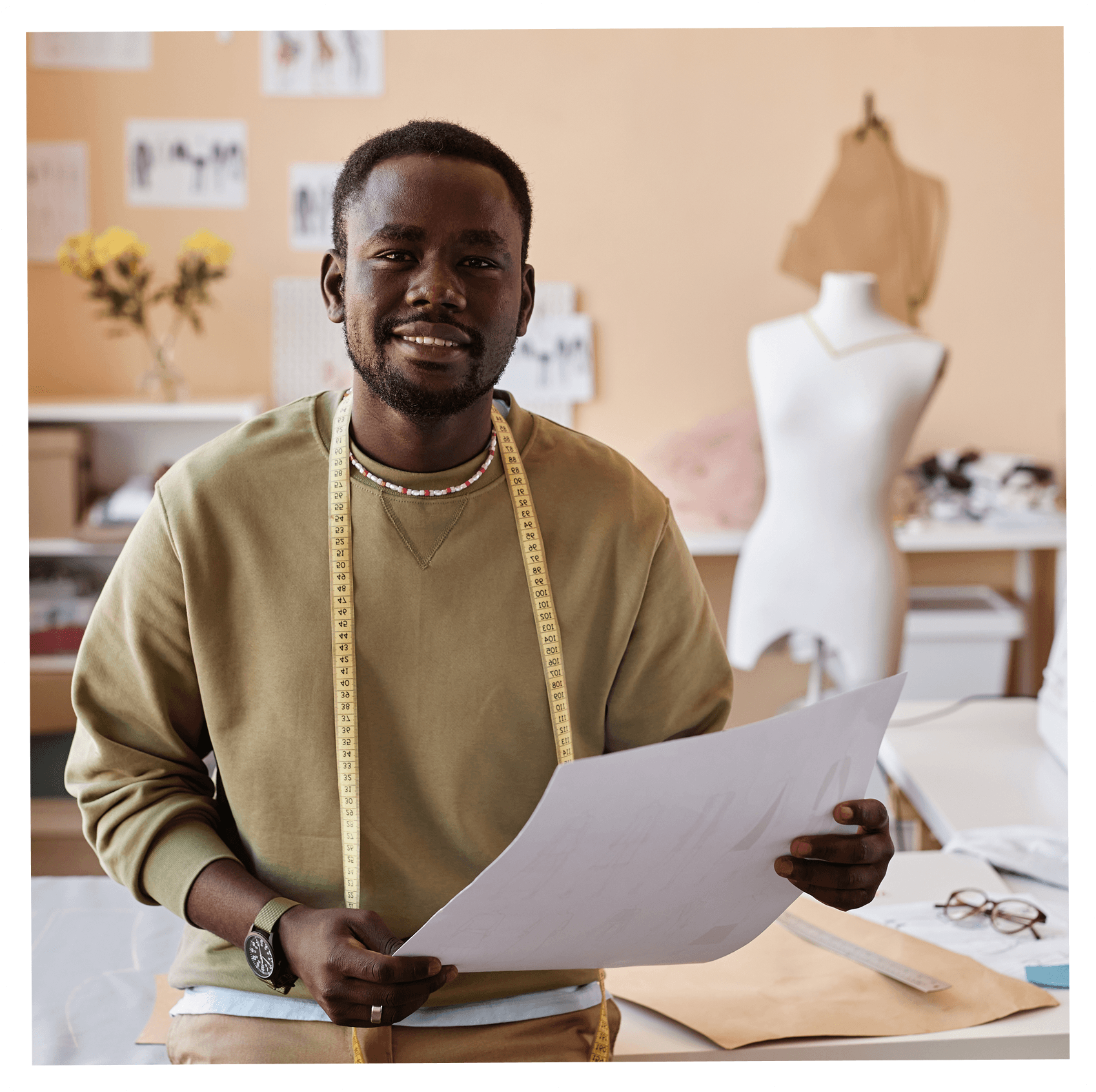Designer holding a sketch in their studio